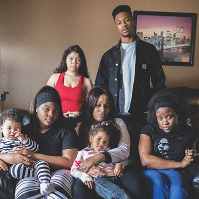 Chestine Gooden, center, with her children and grandchildren in her home