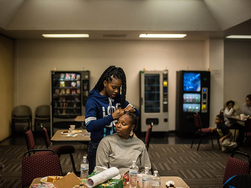 Daisa Love fixes her mother Mercedes Love’s hair.