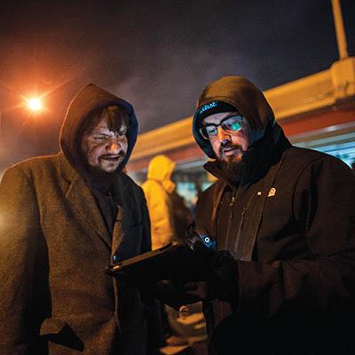 Joseph (left), answers questions for the the Community Service Council census as volunteer Nick Gleason takes down his information.