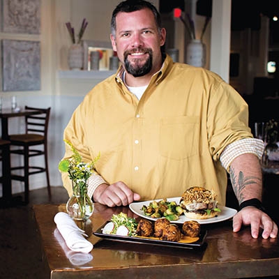 Chef Justin Thompson with Juniper’s Bistro Burger and Lump Crab and Artichoke Beignets