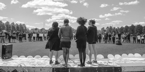 Students take the mic during a mock funeral to protest dramatic cuts at the University of Tulsa.