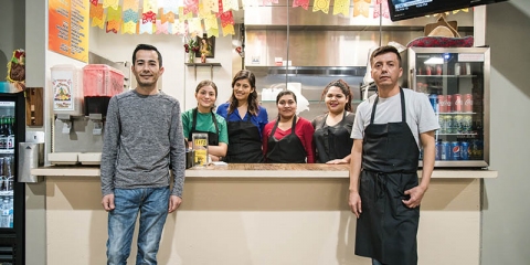 Pollos Asados al Carbon owners Mario and Daniel Ruiz with their crew at &Tacos, Pollos Asados’ location at Mother Road Market