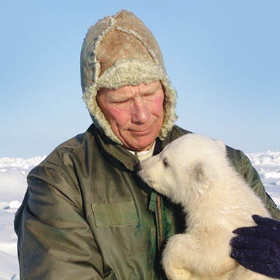 Steven Amstrup with a polar bear cub