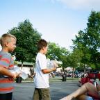 Boys hand out water on June 29 at Utica Square’s concert series, Summer’s Fifth Night  