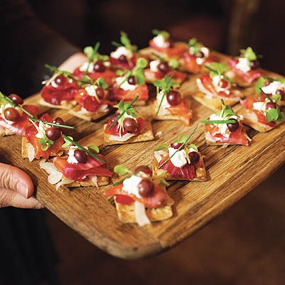 Beet cured salmon, spicy pickled grapes, shaved fennel and fresh chive on rye cracker