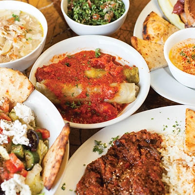 Clockwise from top left: Chicken noodle soup, cabbage rolls, tabouli, Krazy Olive beef trio, eggplant dish, Syrian salad
