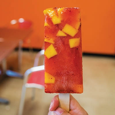 La Tropical’s mango con chili features chunks of fresh mango and a confetti of chili.